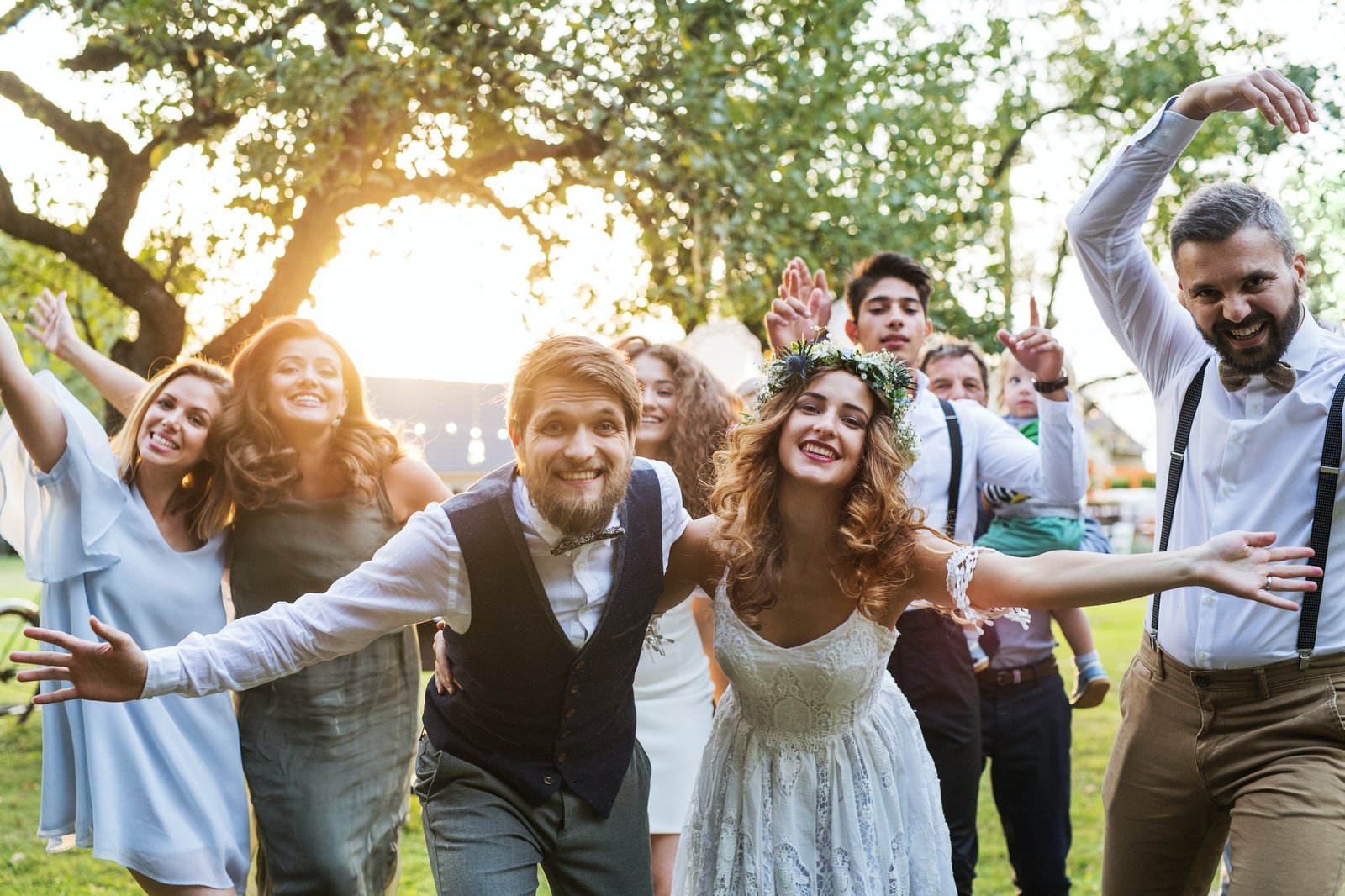 bride-groom-guests-posing-for-the-photo-at-wedding-reception-outside-in-the-backyard-.jpg